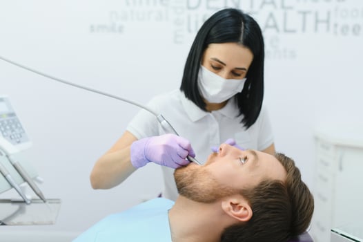 Dental care concept. Handsome young guy at the dentist's office. photo