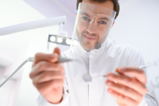 Young male dentist in clinic photo