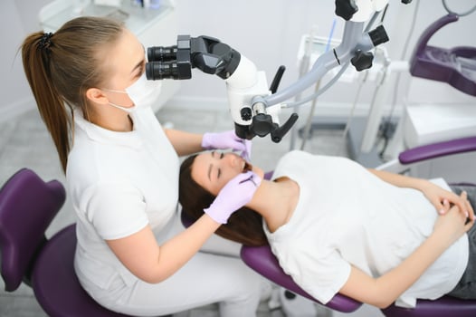 Beautiful young woman having dental treatment at dentist's office. photo