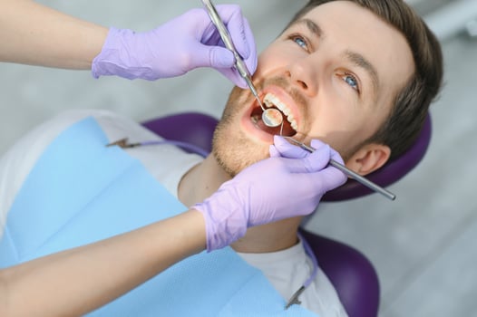 Young man at the dentist. Dental care, taking care of teeth. Picture with copy space for background. photo