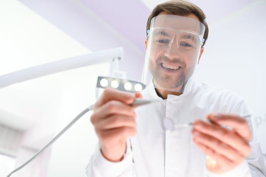 Young male dentist in clinic photo