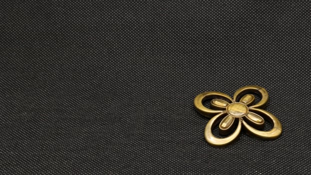 Gold flower brooch isolated photo