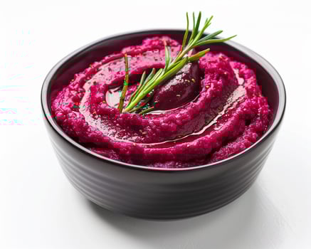 a bowl of beetroot with a sprig of rosemary photo