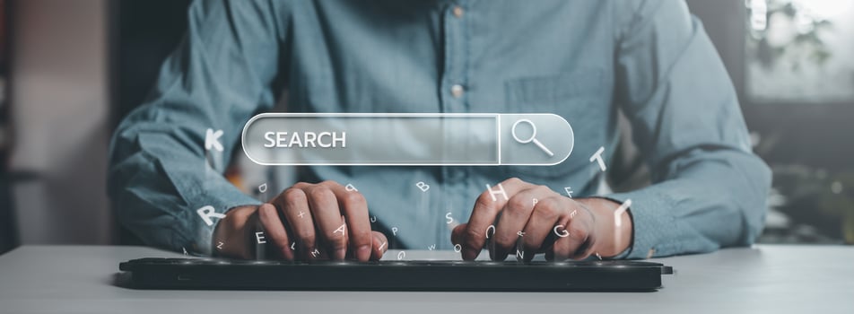 Typing on a keyboard with search bar overlay photo
