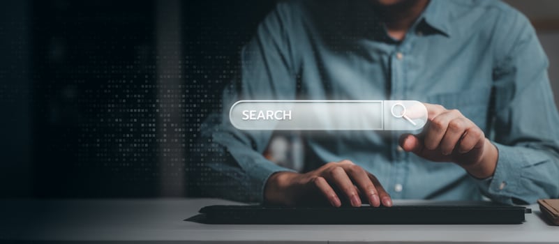 Pointing at a digital search bar on a screen photo