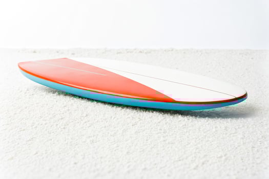 Red and Blue Surfboard on White Sand photo