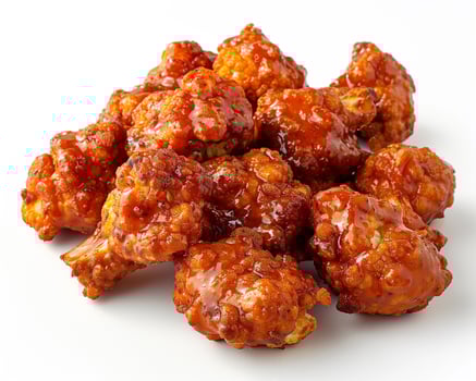 a pile of fried food on a white surface photo