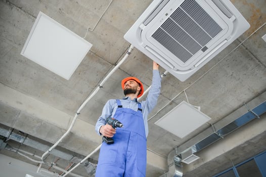 technician service checking and repairing air conditioner indoors photo