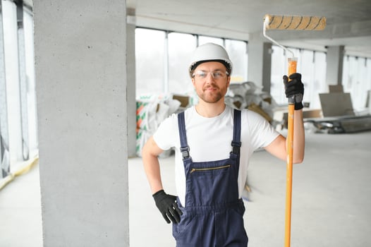 A happy worker proudly standing at his workplace. photo