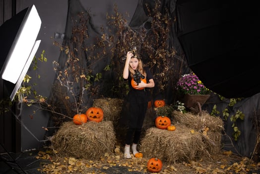 children's photo shoot for Halloween. photo shoot in a studio with decor and professional lighting. happy children preparing for Halloween