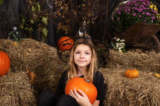 portreit happy girl on Halloween. Funny children in carnival costumes indoors photo