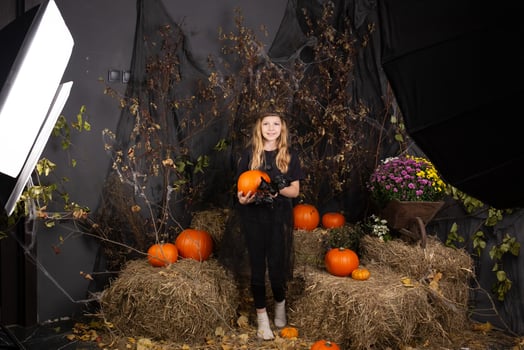children's photo shoot for Halloween. photo shoot in a studio with decor and professional lighting. happy children preparing for Halloween