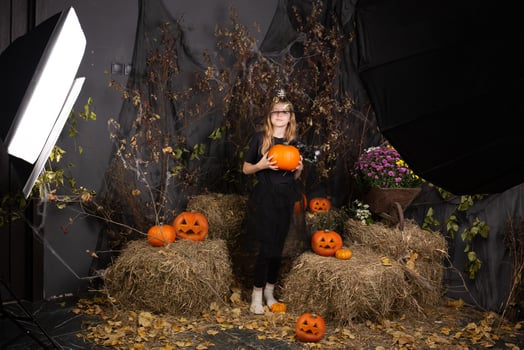 children's photo shoot for Halloween. photo shoot in a studio with decor and professional lighting. happy children preparing for Halloween