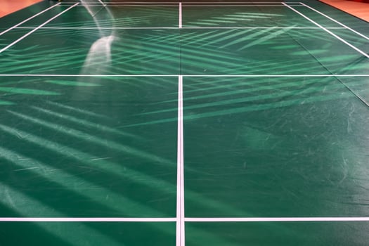 empty green used badminton court background is ready for playing badminton in competition Tournament with spotlight. photo