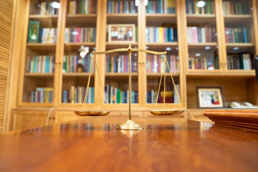 Golden Scale in vintage mood and tone lays on wooden table in front of wood library in Asia. photo