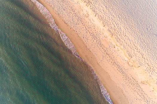 Summer seascape. Aerial drone zenithal view of a beach at dusk photo