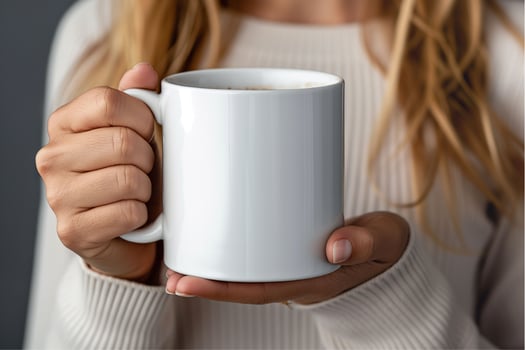 Hand holding white mug mockup photo