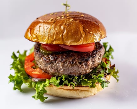hamburger with lettuce, tomato, and cheese photo