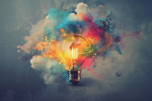 Light bulb exploding with color representing a creative idea photo