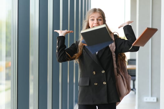 Emotional student girl within walls of institute celebrating successful exam pass, high school or college admission, european employee raised hands feels happy by salary growth, got promoted concept photo