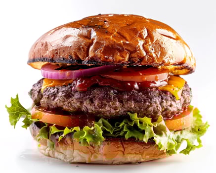 a hamburger with cheese, lettuce and onions photo
