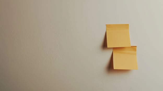 Blank yellow paper taped to the wall for writing messages. photo