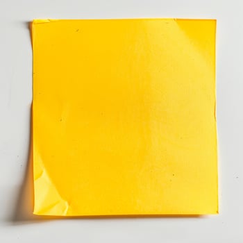 Blank yellow paper taped to the wall for writing messages. photo