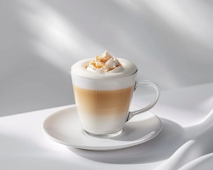 a white cup with whipped cream and cinnamon photo