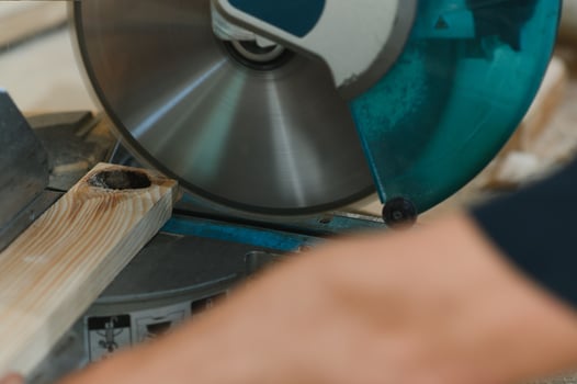 Carpenter working with equipment on wooden table in carpentry shop. photo