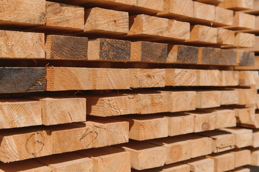 Wooden planks and beams. Air-drying timber stack. Wood air drying. Wood for house construction. Building material. Wood warehouse. photo