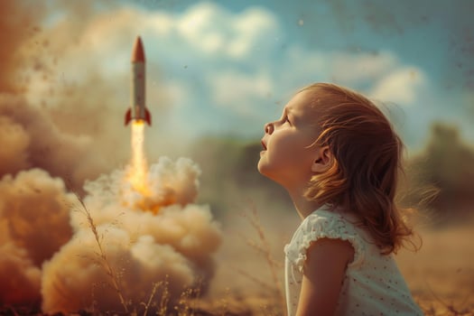 Child watching toy rocket launch photo