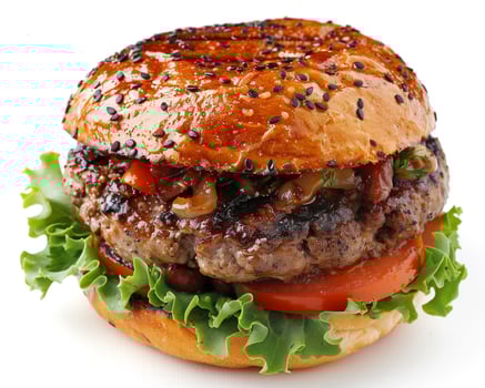 a hamburger with lettuce, tomato and sesame seeds photo