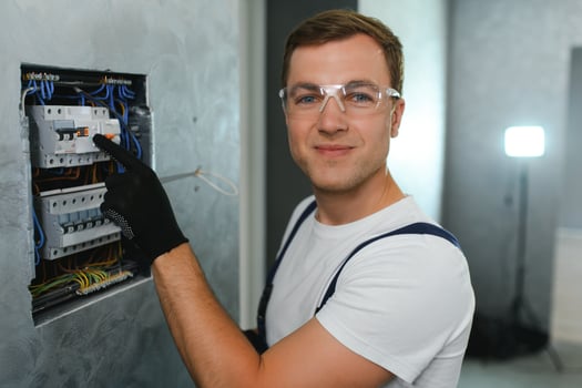 Electrician worker at work on an electrical panel photo