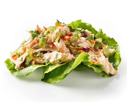 a lettuce leaf with chicken and vegetables on it photo