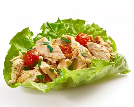 a lettuce leaf with chicken and tomatoes photo