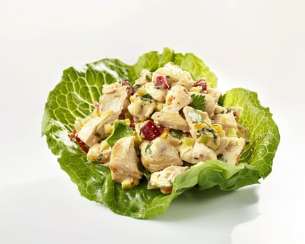 a salad with chicken and vegetables in it photo