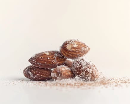 almonds with sugar on white background photo