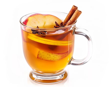 a glass of apple cider with cinnamon and an apple photo
