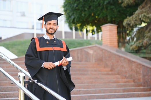 portrait of successful indian student in graduation gown. photo