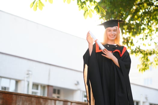 A young female graduate against the background of university. photo