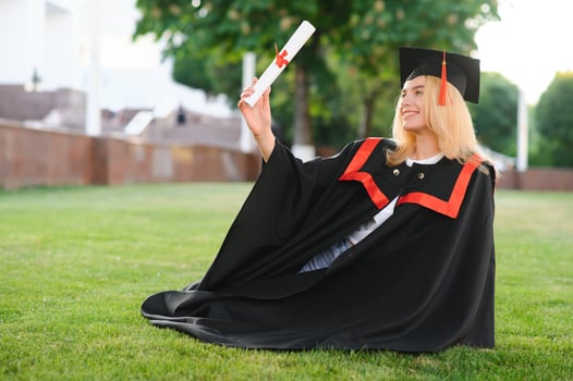 A young female graduate against the background of university. photo