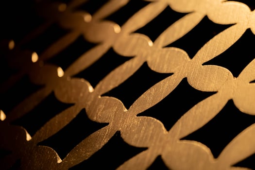 Golden metallic interlocking pattern close-up photo