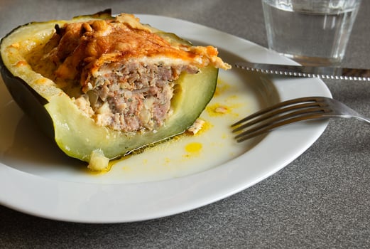 Baked zucchini, stuffed with meat on a white plate photo