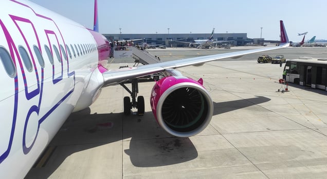 Larnaca, Cyprus - June 29, 2024 Wizz Air plane on the runway showing the engine and landing staircase. Travel, aviation and transportation concept photo