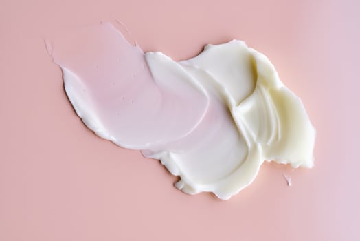 Texture of cosmetic butter on a pink background. Showcasing a thick and nourishing texture. photo