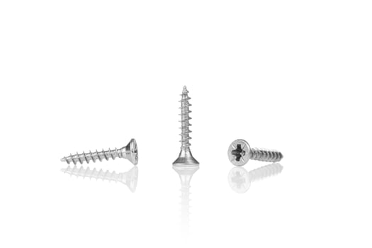 macro screw of silver color on a white background photo
