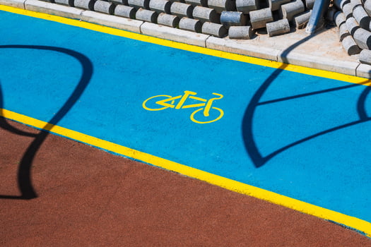 bicycle symbol on a modern new bike path painted with blue paint in park in Tashkent in Uzbekistan photo