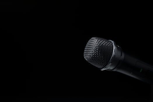 Black and silver microphones in the studio on a black and dark background. Professional recording equipment. Top view. photo