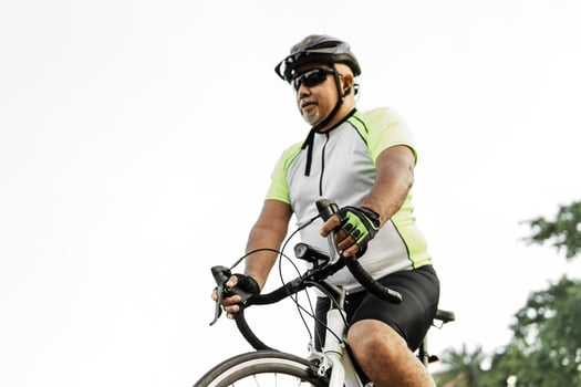 Adult man wearing a safety helmet driving of the city with his bicycle. photo