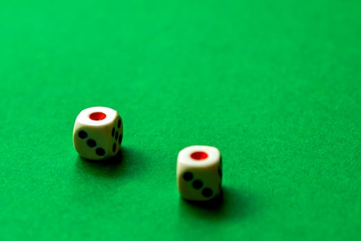gaming dice on a rich green background. casino, betting and entertainment photo